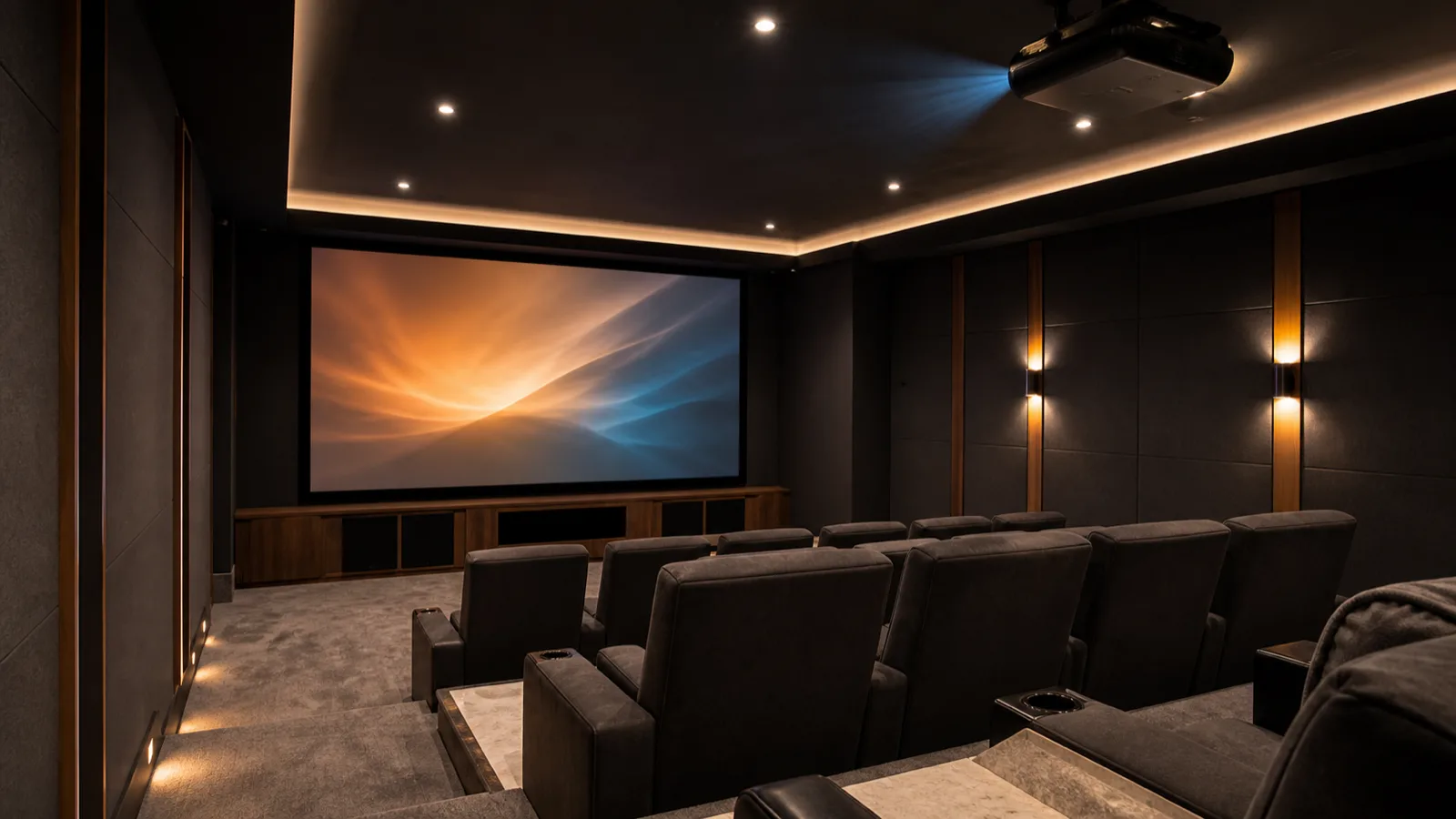 A dedicated home cinema room with a ceiling-mounted projector throwing a bright image onto a wide matte screen, tiered seating, dark acoustic wall panels.