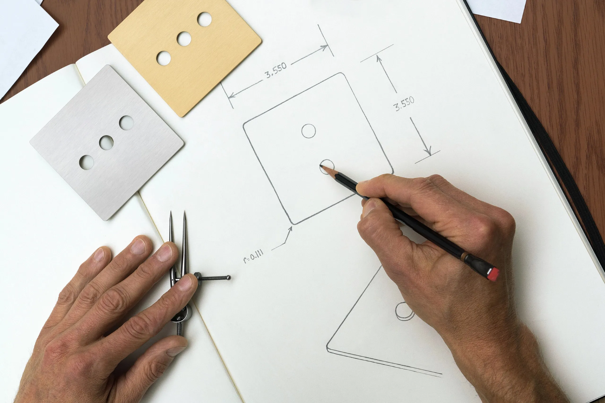 Hands drawing dimensional sketches of a square keypad plate next to metal sample faces.