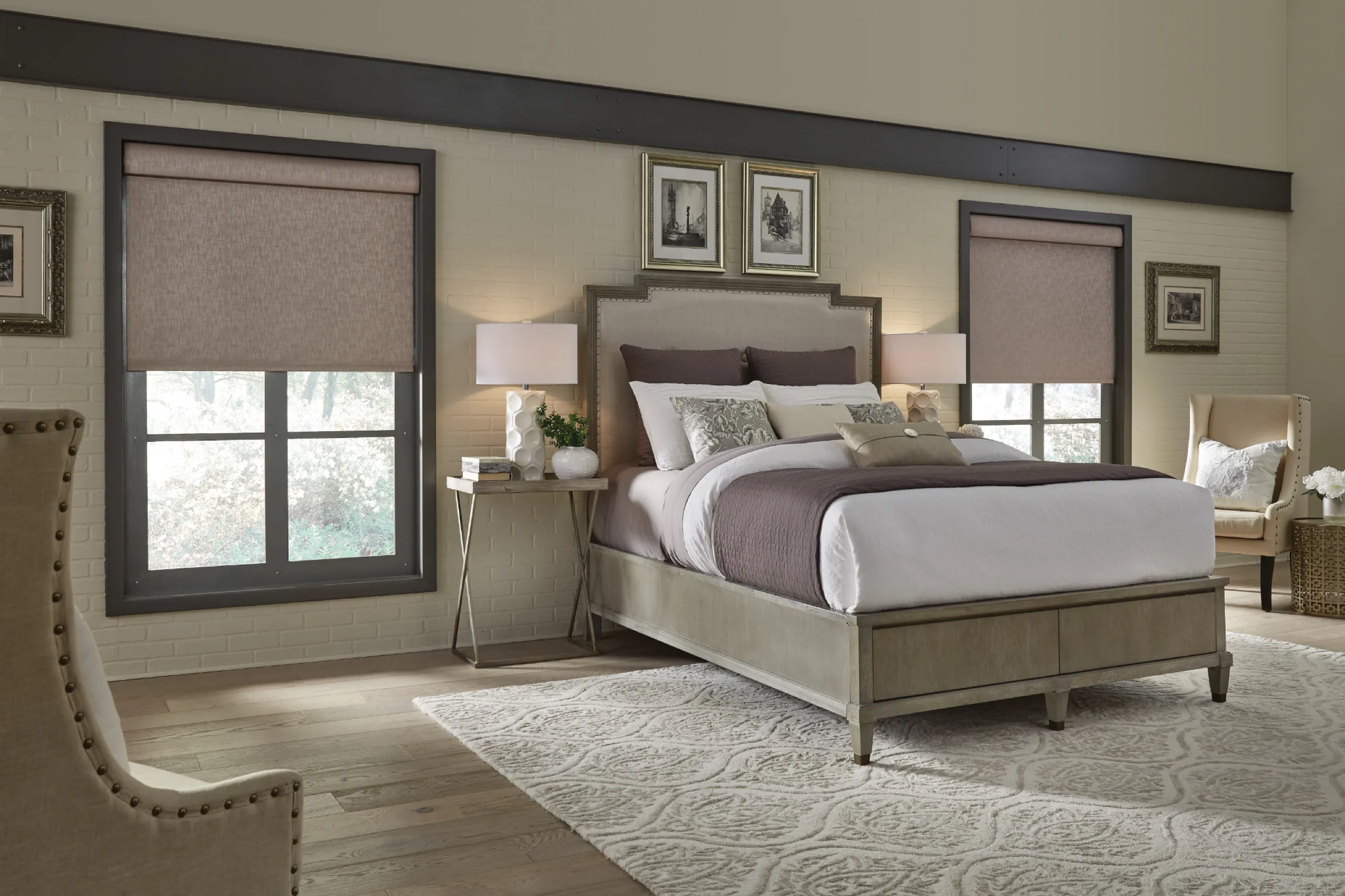 Bedroom with partially raised taupe roller shades showing trees outside multi-pane windows