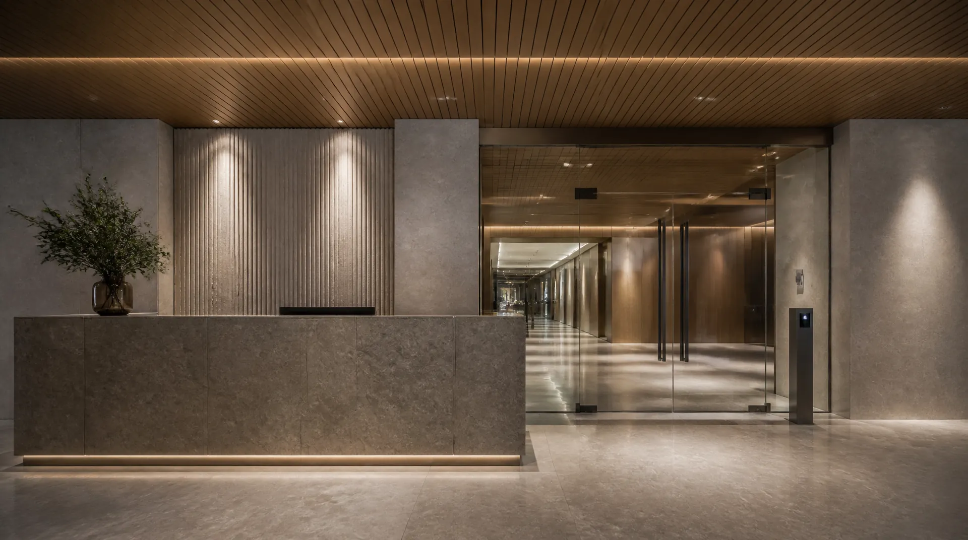 Office reception desk beside a glass entry door fitted with a slim badge reader, staff member walking through.