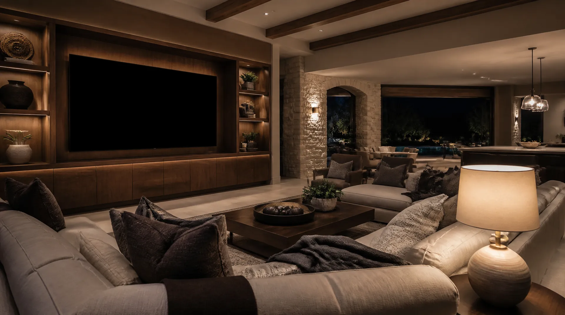 Media room in daylight with a large display above a low console, floor lamps on, and seating facing the far wall.